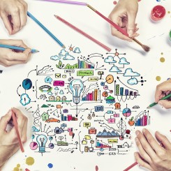 Top view of people hand drawing business creative concept with paints